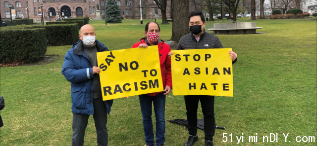 A group of men holding signs Description automatically generated with medium confidence