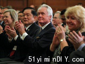 Sen. Victor Oh, second from left, listens as Prime Minister Stephen Harper speaks to his national caucus in Ottawa in 2013.