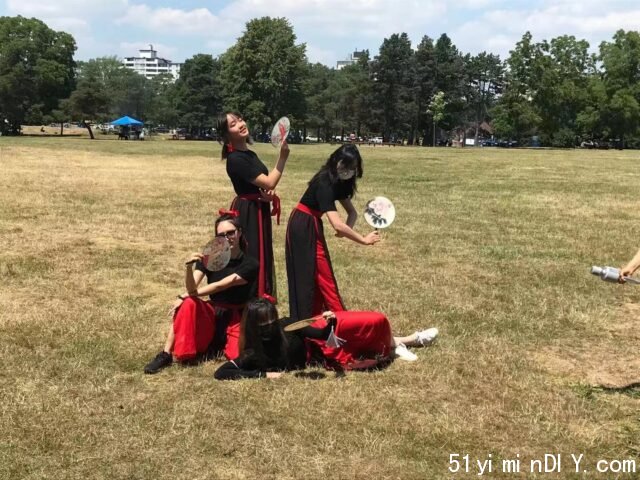 A group of people playing with a ball in a field Description automatically generated with low confidence