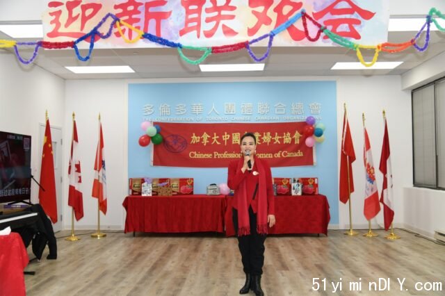 A person standing in front of a stage with flags

Description automatically generated with low confidence